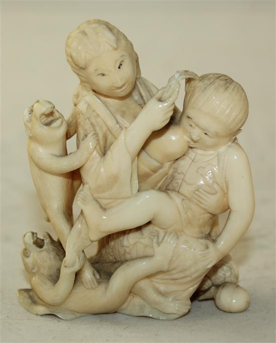 A Japanese ivory okimono of a mother suckling a child, Meiji period, 7.7cm